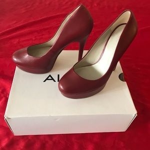 Red leather heels. Small scratch on the side.